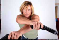 Woman Adult Muscular White Fighting with gun Standing poses Sportswear
