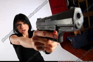silvia-standing-aiming-pistol
