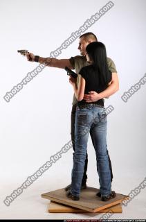 2010 02 COUPLE STANDING AIMING GUNS 01 B