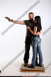 2010 02 COUPLE STANDING AIMING GUNS 00 B