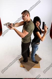 2010 02 COUPLE STANDING AIMING GUNS2 01 A