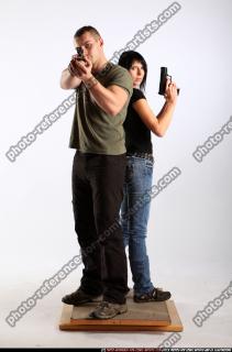 2010 02 COUPLE STANDING AIMING GUNS2 00 B