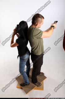 2010 02 COUPLE STANDING AIMING GUNS2 05 A