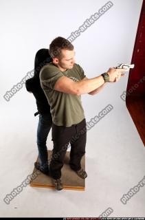 2010 02 COUPLE STANDING AIMING GUNS2 06 A