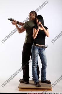 2010 02 COUPLE STANDING AIMING GUNS2 02 B