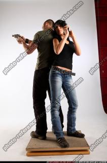 2010 02 COUPLE STANDING AIMING GUNS2 02 C