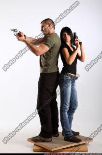 2010 02 COUPLE STANDING AIMING GUNS2 01 B