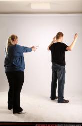 Man & Woman Adult Average White Fighting with gun Standing poses Casual
