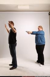 Man & Woman Adult Average White Fighting with gun Standing poses Casual