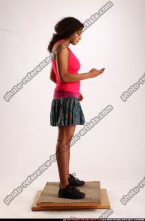 ELLIE-STANDING-USING-CELLPHONE