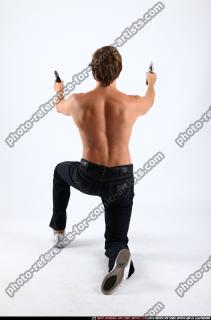 2010 09 PATRICK KNEELING SHOOTING DUAL PISTOLS 04 B