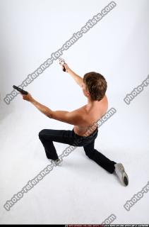 2010 09 PATRICK KNEELING SHOOTING DUAL PISTOLS 03 A