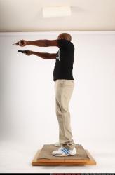 Man Old Average Black Fighting with gun Standing poses Casual