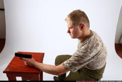 Man Adult Average White Fighting with gun Sitting poses Army