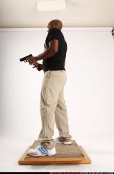 Man Old Chubby Black Fighting with gun Standing poses Casual