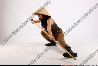 naomi-kneeling-stick-pose