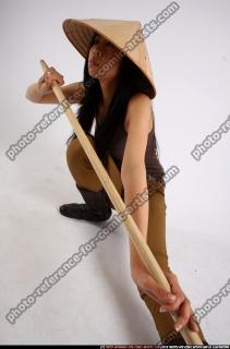 naomi-kneeling-stick-pose