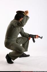 Man Adult Average Fighting with submachine gun Kneeling poses Army Asian