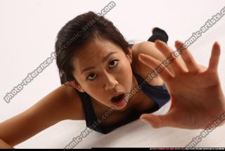 naomi-laying-reaching-for