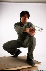 Man Adult Average Fighting with gun Kneeling poses Army Asian