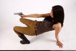 Woman Young Athletic Fighting with gun Laying poses Asian