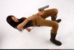 Woman Young Athletic Fighting with gun Laying poses Asian