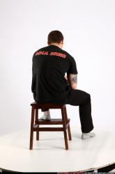 Man Adult Athletic White Fighting with gun Sitting poses Casual