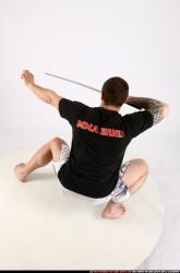 Man Adult Athletic White Fighting with sword Kneeling poses Sportswear