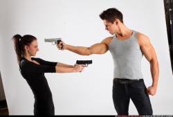 Man & Woman Adult Athletic White Fighting with gun Standing poses Casual