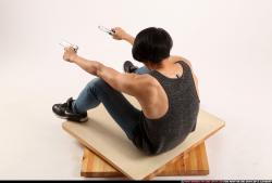 Man Young Athletic Fighting with gun Sitting poses Casual Asian