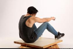 Man Young Athletic Fighting with gun Sitting poses Casual Asian