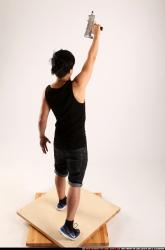 Jerald-mob-standing-raising-uzi