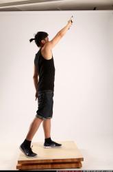 Jerald-mob-standing-raising-uzi