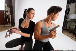 Man & Woman Adult Athletic White Fighting with gun Kneeling poses Casual