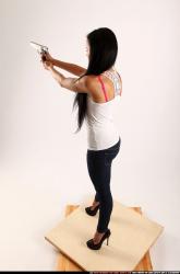 Woman Young Athletic Fighting with gun Standing poses Casual Latino