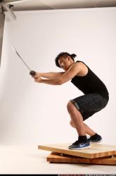 Man Young Athletic Fighting with sword Kneeling poses Sportswear Asian