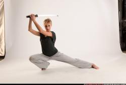 Woman Adult Athletic White Fighting with sword Kneeling poses Sportswear