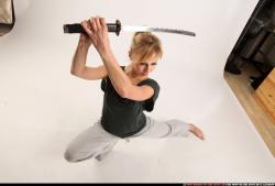 Woman Adult Athletic White Fighting with sword Kneeling poses Sportswear