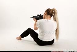 Woman Young Average Fighting with submachine gun Sitting poses Casual Asian