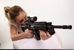 Woman Young Average Fighting with submachine gun Kneeling poses Casual Asian