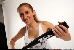 Woman Adult Athletic White Sitting poses Casual Fighting with bat