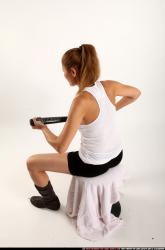 Woman Adult Athletic White Sitting poses Casual Fighting with bat