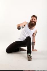 Man Adult Athletic White Kneeling poses Casual Fighting with shotgun