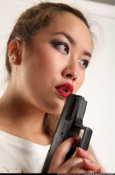 Woman Young Average Fighting with gun Standing poses Casual Asian