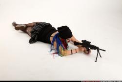 Woman Young Average White Fighting with submachine gun Laying poses Casual