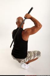 Man Adult Athletic Black Fighting with sword Kneeling poses Army