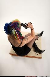 dolores-sitting-pistol-knife-pose