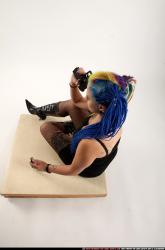 dolores-sitting-pistol-knife-pose