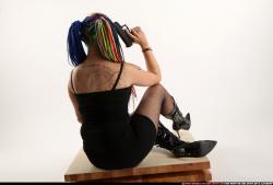 dolores-sitting-pistol-knife-pose