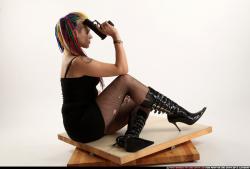 dolores-sitting-pistol-knife-pose